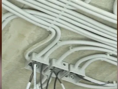 Construction site: conduit runs converging on junction boxes away from the modelled route.